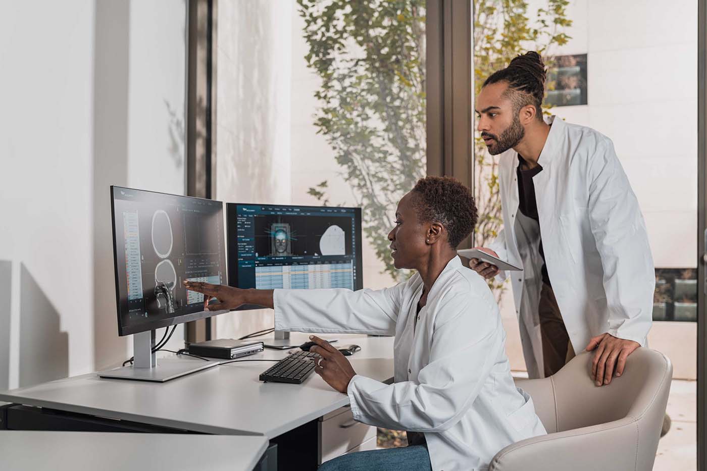 Scientists looking at a monitor screen.